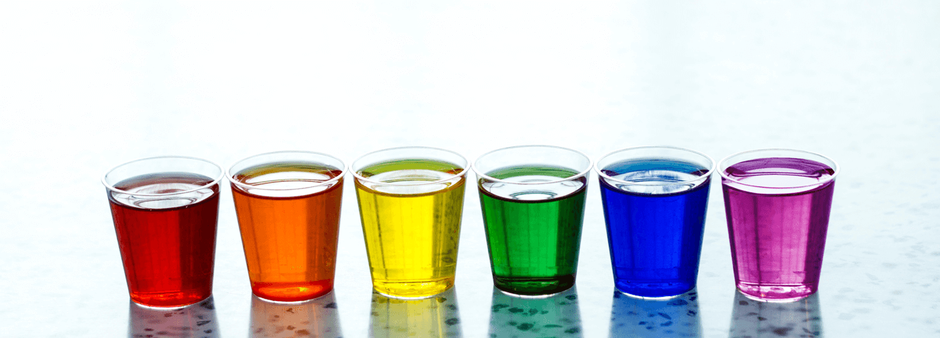 cups containing multi-colored liquid