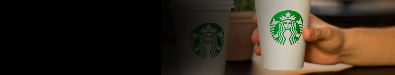 hand holding white starbucks cup