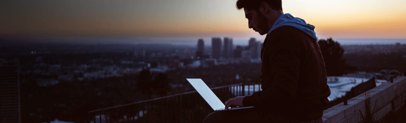 man updating through laptop